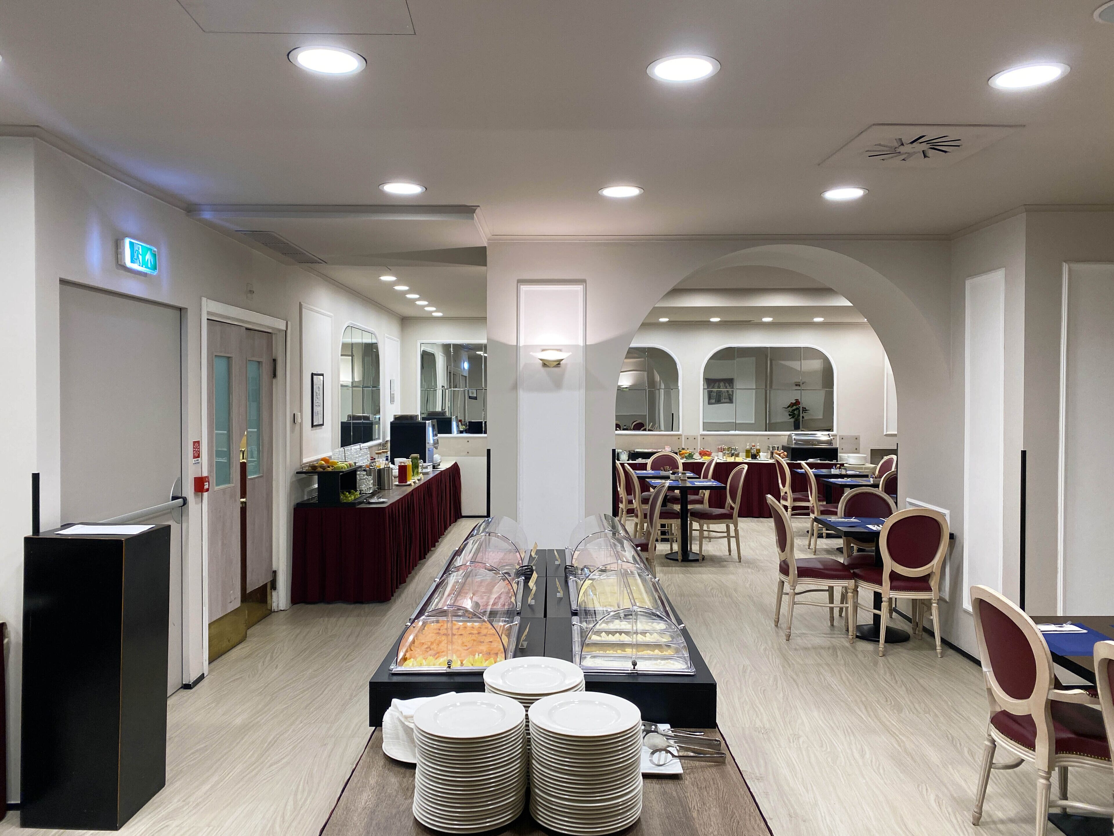 A buffet setup with multiple serving stations and a long counter with food displays.