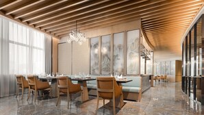 A modern dining area with wooden ceiling beams, a central chandelier, and a seating arrangement with tables and chairs. - Sheraton Chengdu Lido Hotel (Chengdu)