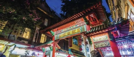 A traditional Chinese building with ornate architecture, including a red roof and intricate designs.