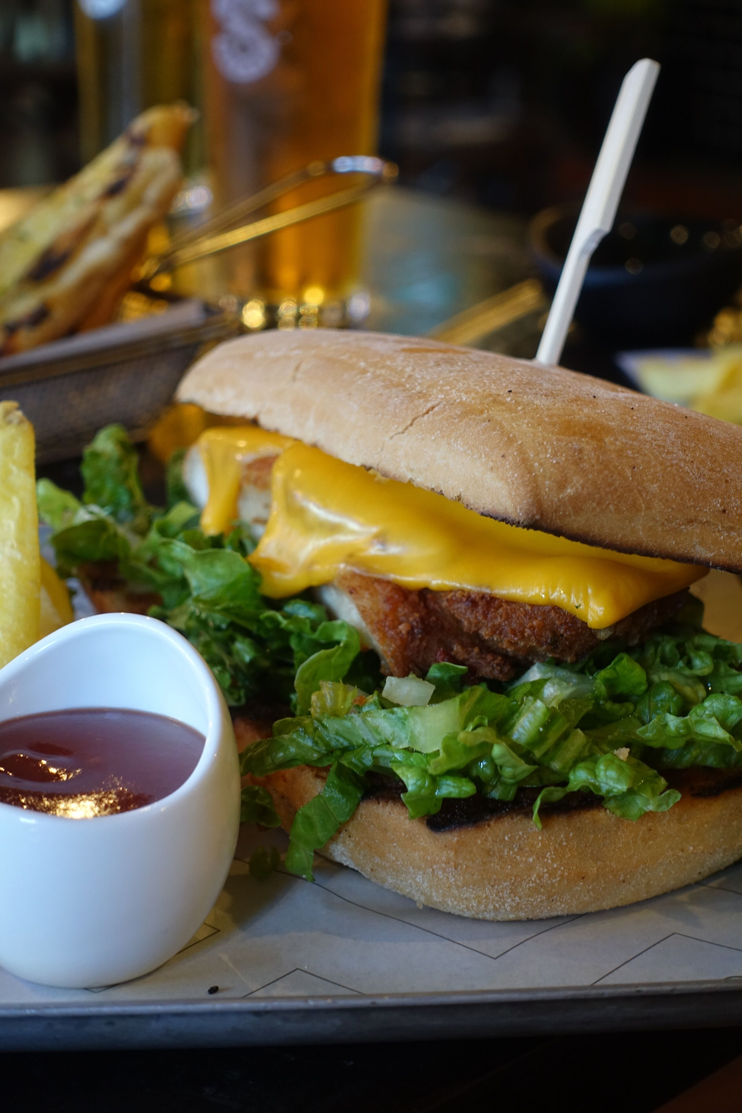 En smörgås med ett bröd, ost, sallad och en portion pommes frites.