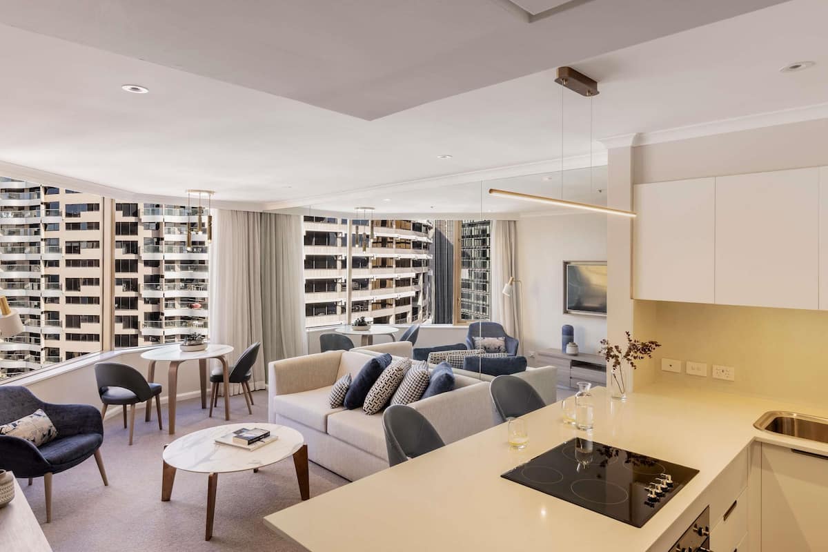 A modern apartment with a living area, dining space, and kitchen.