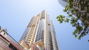 A high-rise building with multiple floors, large windows, and a modern architectural design.