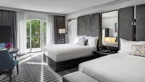 A hotel room with two beds, a desk, and a chair. There is a large window with curtains, a flat-screen TV, and a bedside table with a lamp. - InterContinental Sydney Double Bay by IHG (Double Bay)