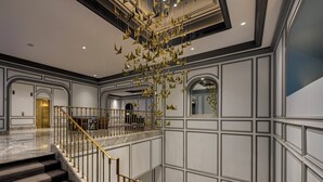 A grand interior with a marble staircase, a chandelier, and a high ceiling. - InterContinental Sydney Double Bay by IHG (Double Bay)