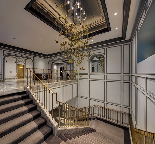A grand interior with a marble staircase, a chandelier, and a high ceiling. - InterContinental Sydney Double Bay by IHG (Double Bay)