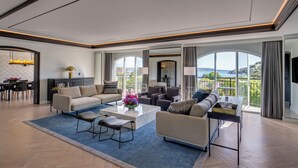 A spacious living room with a large sofa, a coffee table, and a view of the city through large windows. - InterContinental Sydney Double Bay by IHG (Double Bay)