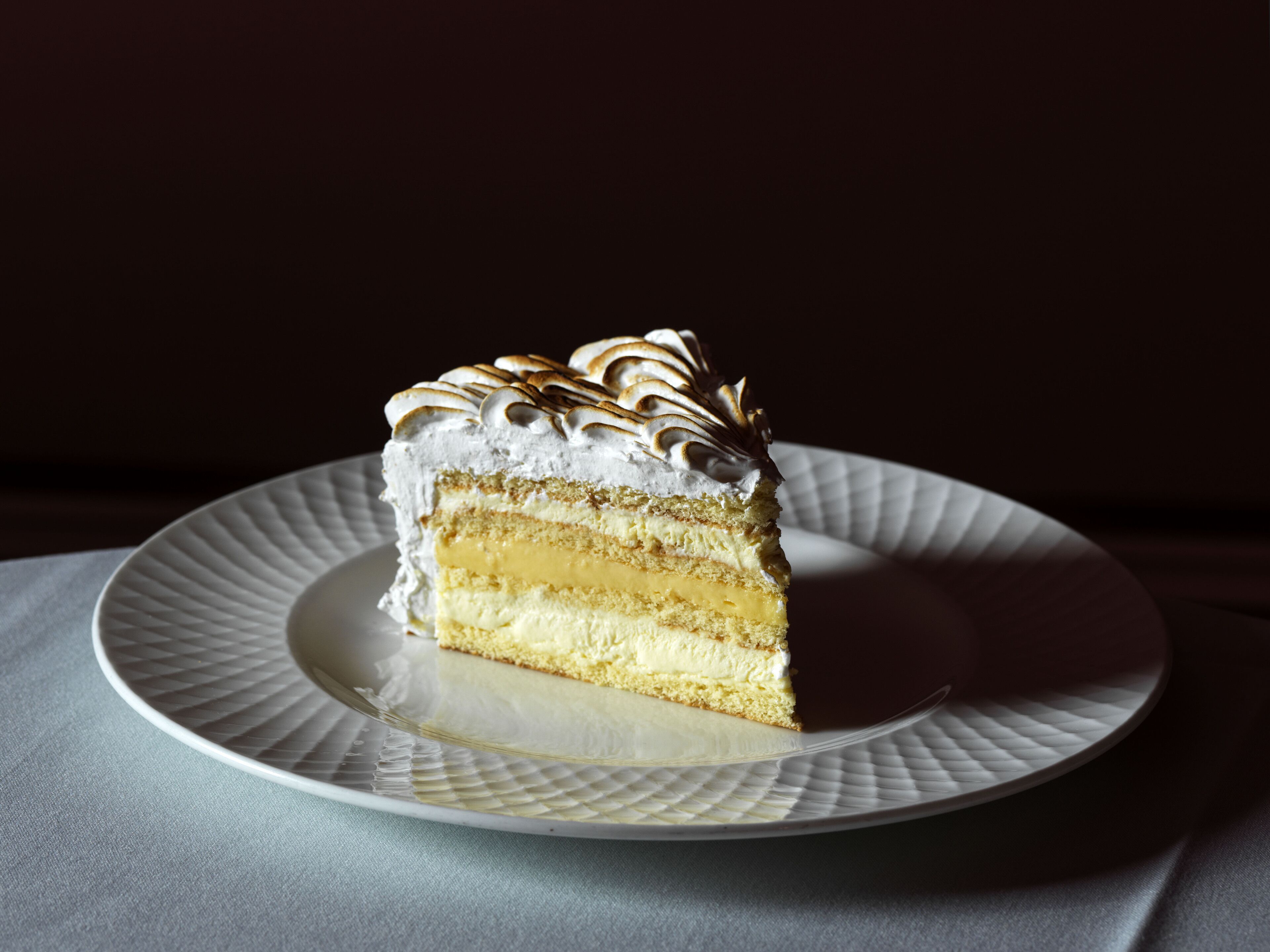 A slice of layered cake on a textured plate.