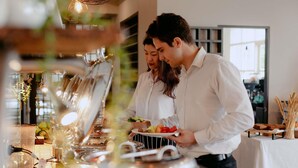 A buffet setup with a variety of food items and a person serving. - Mercure Sydney Parramatta (Rosehill)