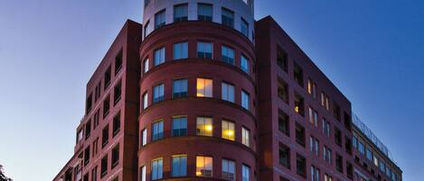 A multi-story hotel with a prominent circular sign at the top.