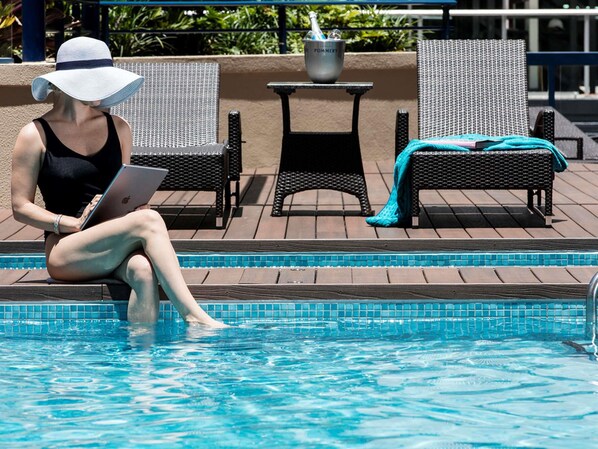 Outdoor pool, open 7:00 AM to 9:00 PM, pool loungers