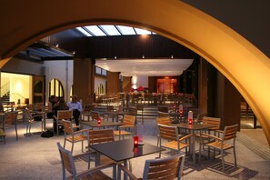 Enjoy dining in a spacious, open layout with tables and comfortable chairs.