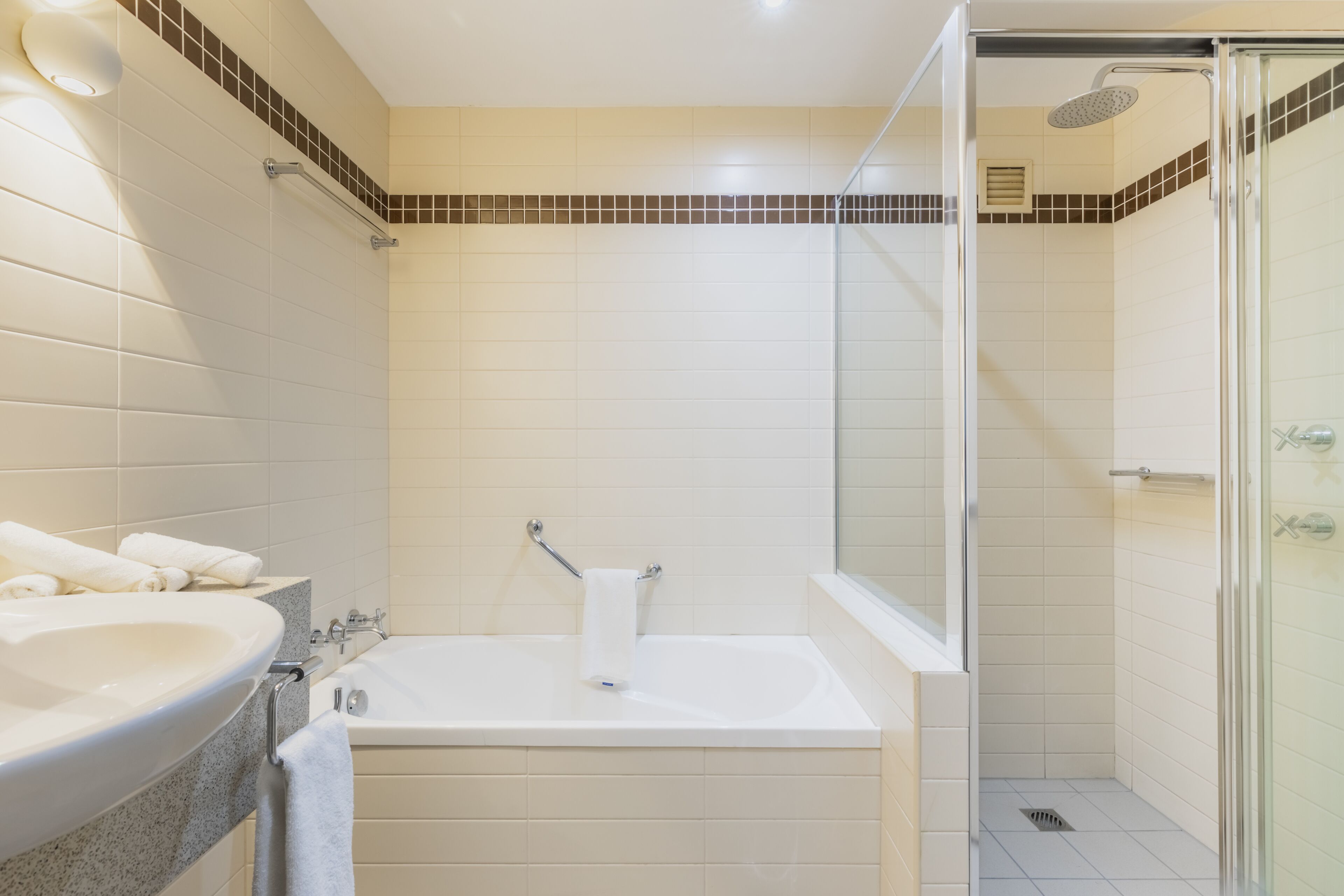A bathroom with a bathtub, a shower, and a sink.