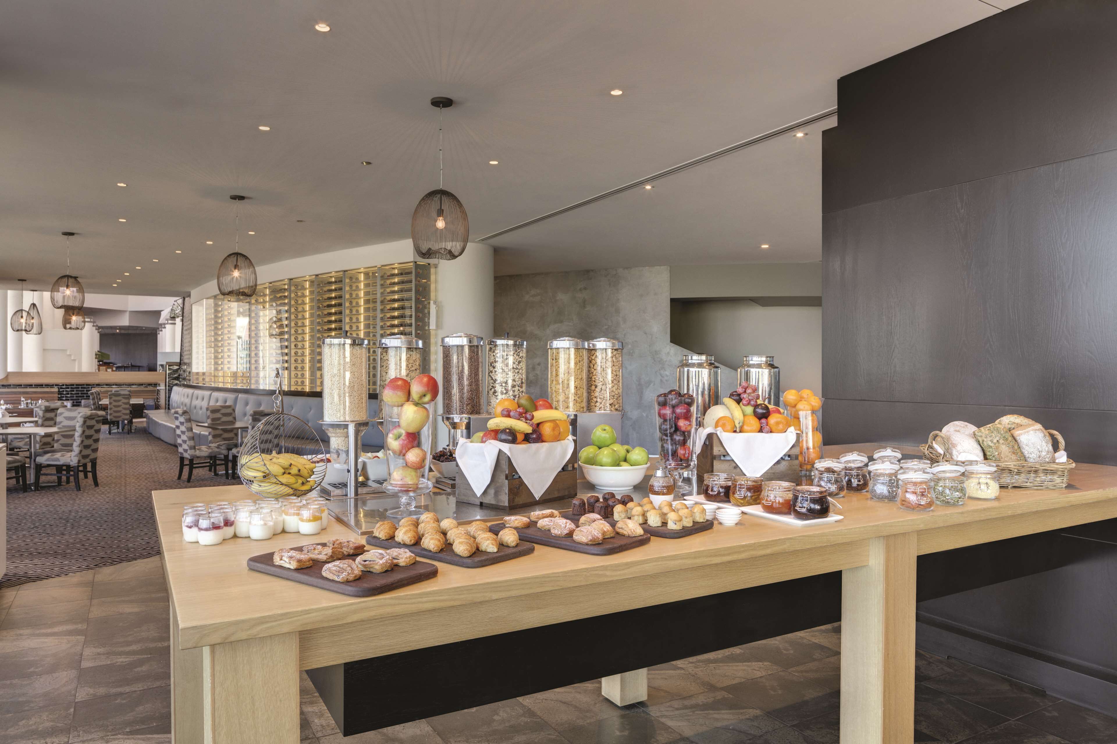 A buffet setup with various food items and condiments.