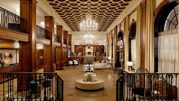 A grand lobby with a central round seating area, ornate ceiling, and a chandelier. - The Lord Nelson Hotel & Suites (Halifax)