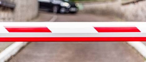 A blurred view of a road with a barrier in the foreground.