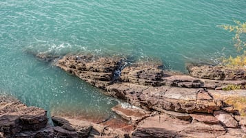 A rocky shoreline with clear water.