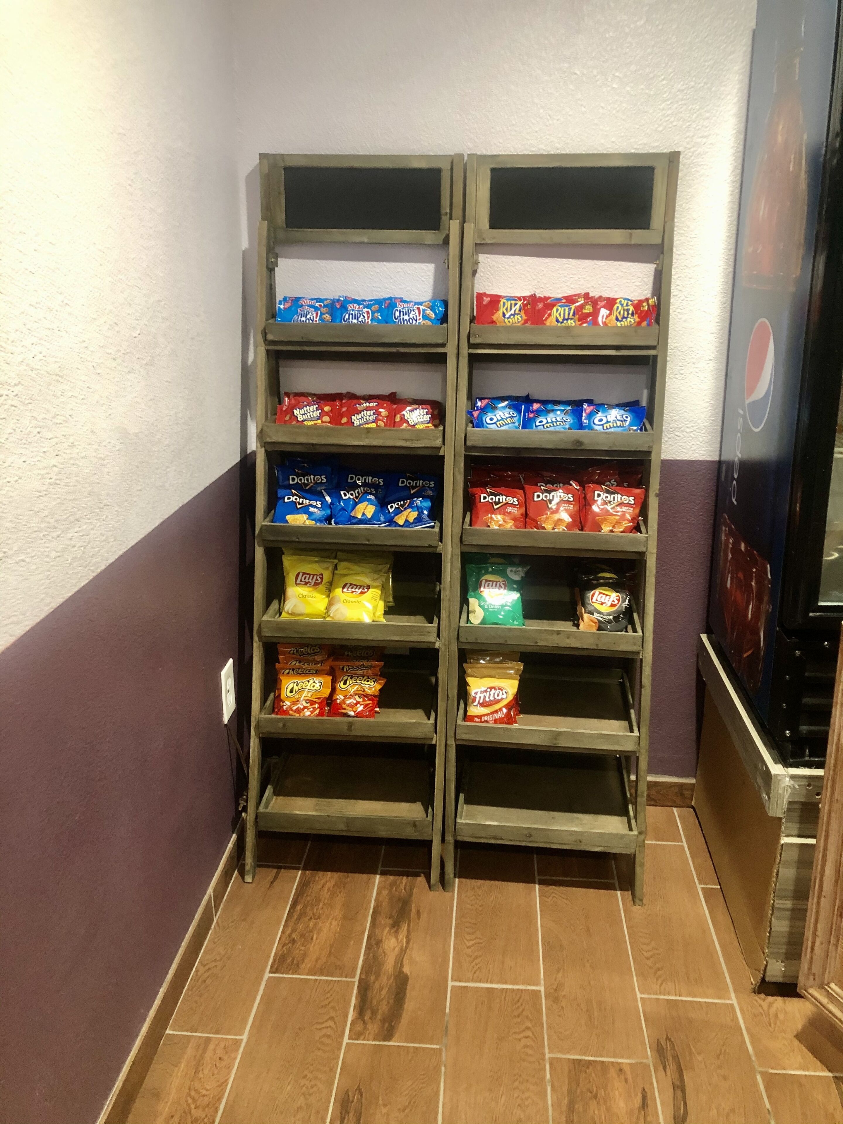 A snack display with various brands of chips and snacks.