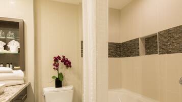 A bathroom with a toilet, bathtub, and shower curtain.