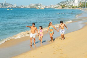 On the beach, sun-loungers, beach umbrellas, beach towels