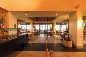 A spacious indoor area with multiple seating arrangements, a reception desk, and large windows providing views. - Friendly Fun Vallarta Different Experiences (Puerto Vallarta)