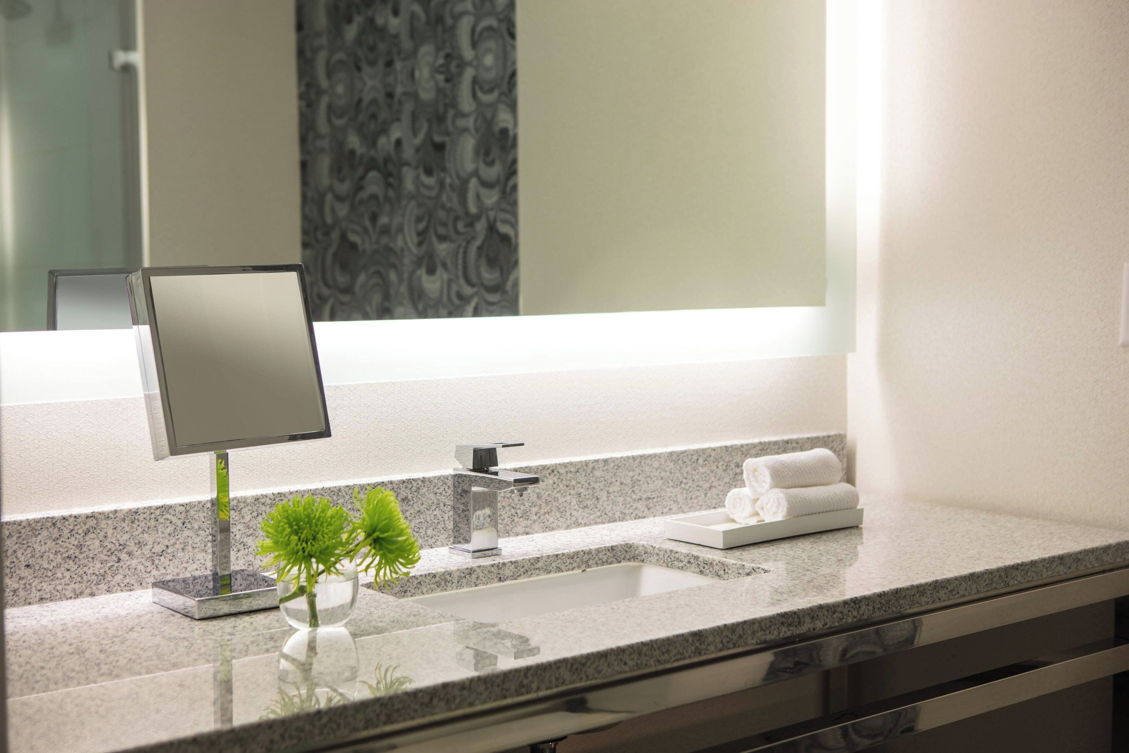 designer toiletries, hair dryer, towels