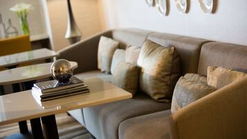 A modern living room with a sofa, a coffee table, and a lamp.