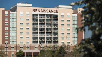 A multi-story hotel named 'Renaissance' with a modern architectural design, featuring balconies and a central atrium.