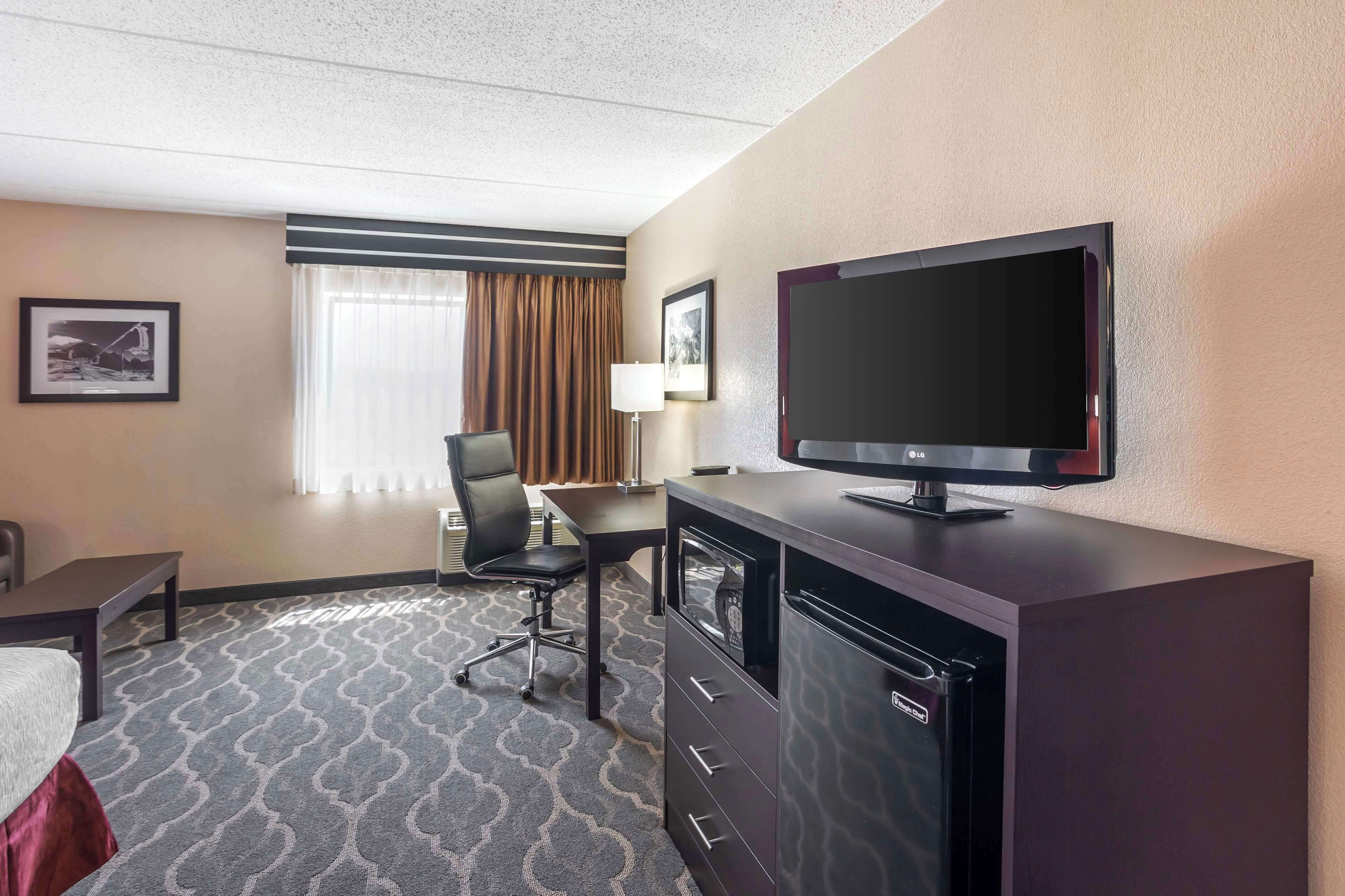 laptop workspace, blackout curtains, iron/ironing board