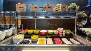 A buffet with various food items including fruits, cheeses, and meats. - Doubletree by Hilton London Marble Arch (London)