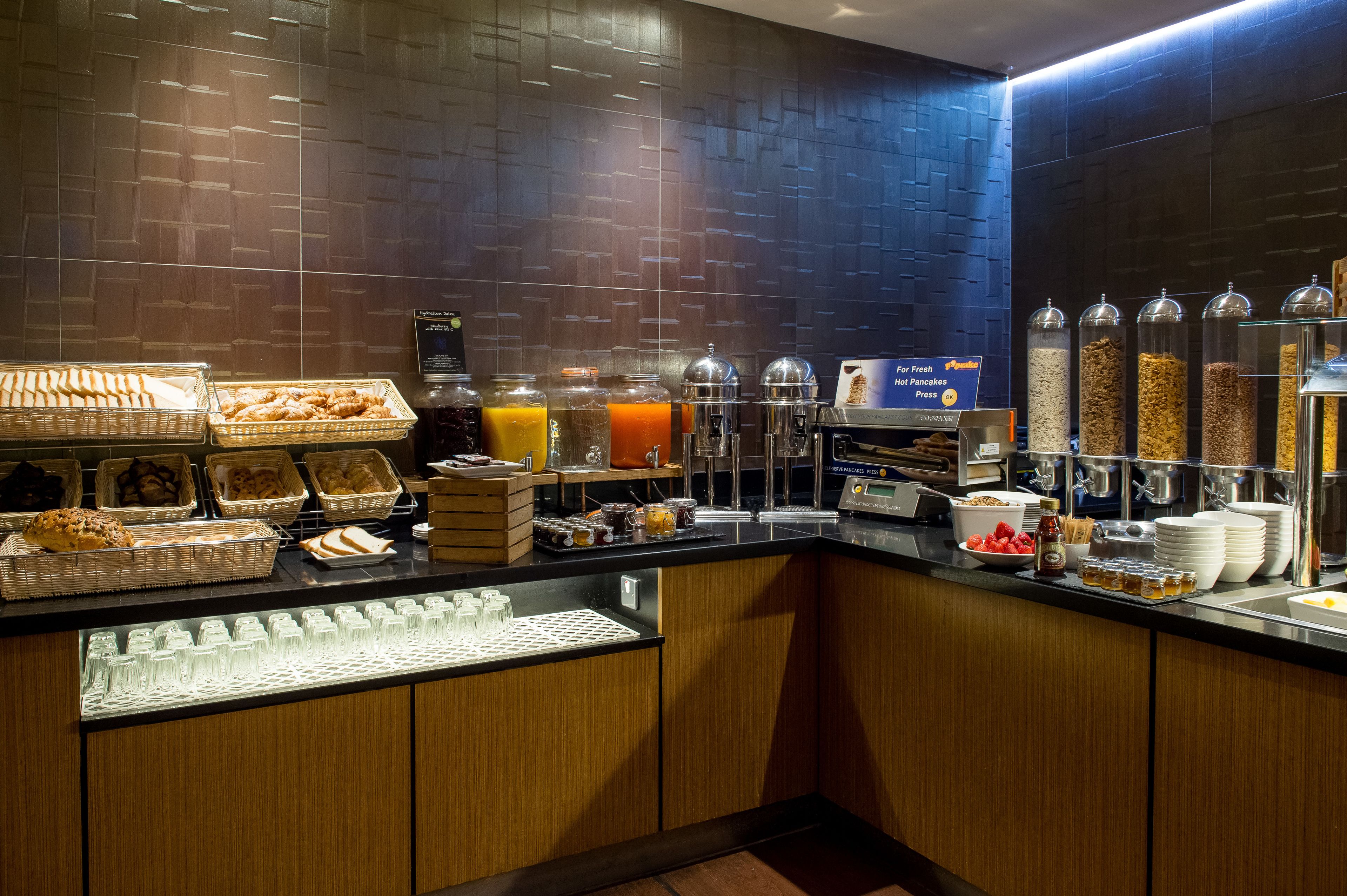 A breakfast buffet with various food items and beverages.