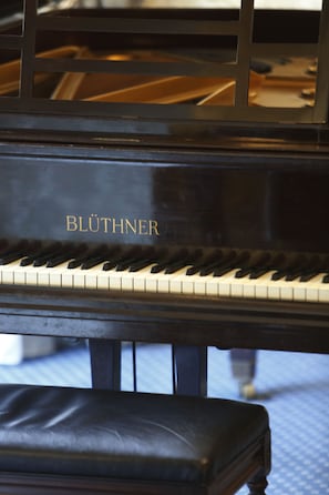 A grand piano with the brand name "BLUTHNER" on its lid. - Best Western Swiss Cottage Hotel (London)