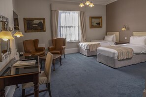 A hotel room with a desk, two chairs, a bed, and a window with curtains. - Best Western Swiss Cottage Hotel (London)