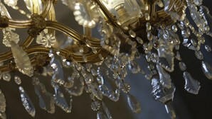 A chandelier with multiple arms and crystal decorations.