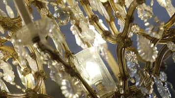 A chandelier with multiple arms and crystal decorations.