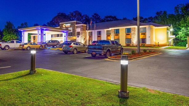 A hotel with a gas station, multiple parking spaces, and a well-lit entrance. - Comfort Suites Eufaula North (Eufaula)