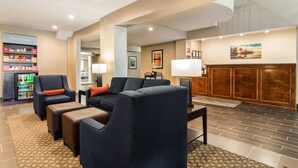 A hotel lobby with seating areas, a kitchenette, and a fireplace. - Comfort Suites Eufaula North (Eufaula)