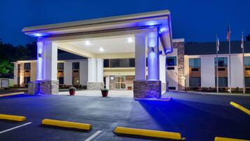 Welcome to our hotel, featuring a modern entrance with a canopy structure and easy access via stairs.