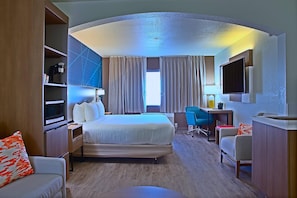 A hotel room with a bed, desk, chair, TV, and a minibar. - Comfort Inn & Suites Sierra Vista Near Ft Huachuca (Sierra Vista)