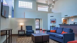 A spacious lobby with a blue sofa, a small table, a chair, and a patterned rug. - Comfort Inn & Suites Sierra Vista Near Ft Huachuca (Sierra Vista)