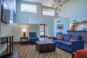 A spacious lobby with a blue sofa, a small table, a chair, and a patterned rug. - Comfort Inn & Suites Sierra Vista Near Ft Huachuca (Sierra Vista)