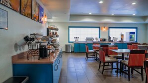 A restaurant with a counter, chairs, tables, and a view through large windows. - Comfort Inn & Suites Sierra Vista Near Ft Huachuca (Sierra Vista)