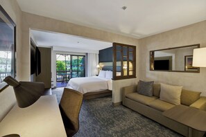 A hotel room with a bed, a sofa, a desk, and a large window. - Holiday Inn Express & Suites Carpinteria by IHG (Carpinteria)