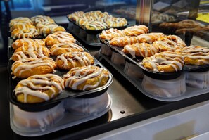 A display case with trays of pastries. - Holiday Inn Express & Suites Carpinteria by IHG (Carpinteria)