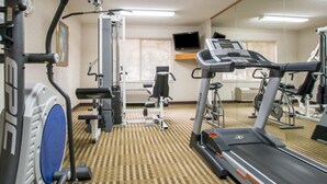 A gym with treadmills, weight machines, and a mirrored wall. - Quality Suites San Diego Otay Mesa (San Diego)