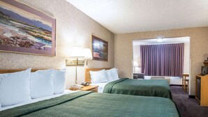 A hotel room with two beds, a desk, a chair, a television, and a painting on the wall. - Quality Suites San Diego Otay Mesa (San Diego)