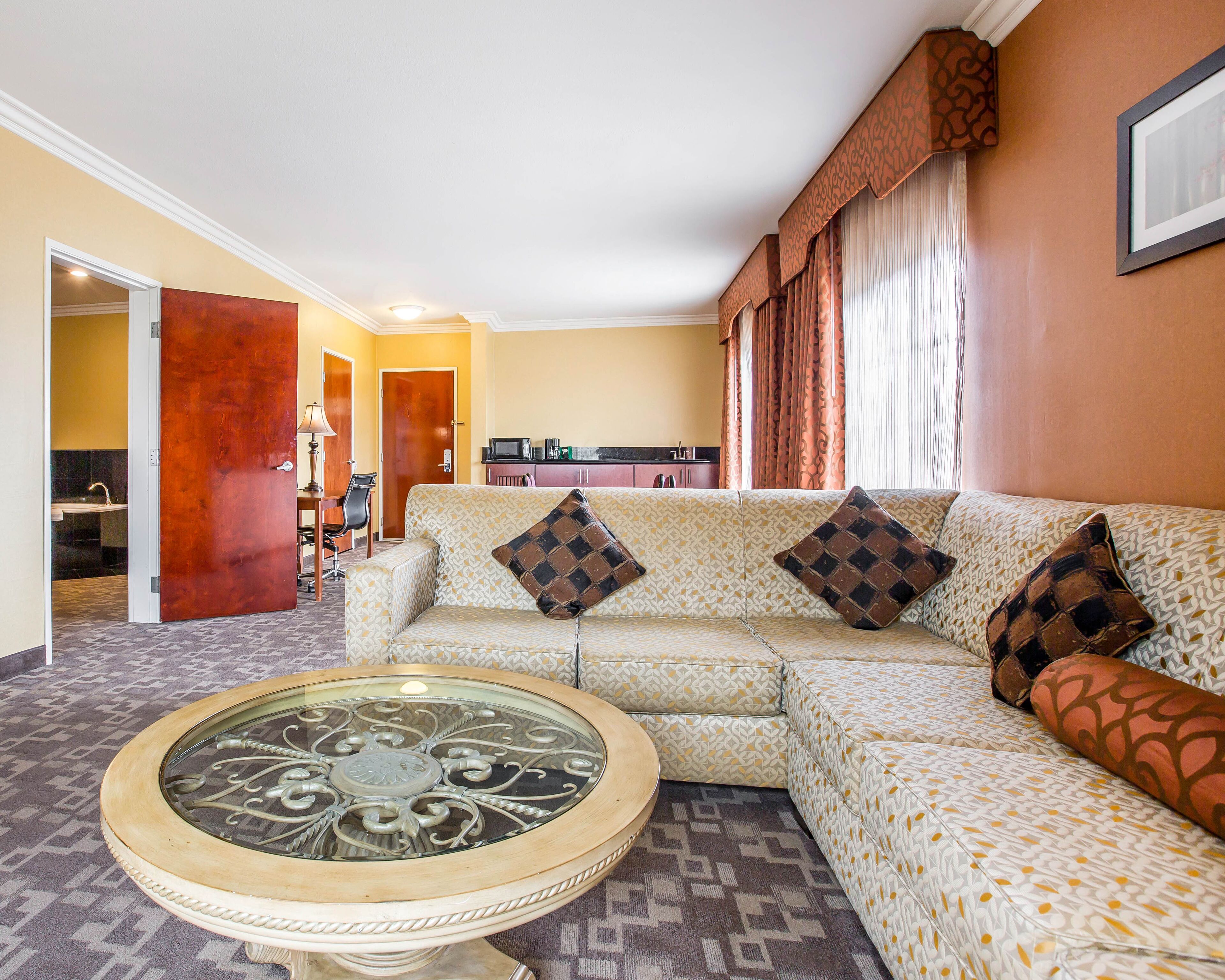 superior suite, 1 king bed, sofa bed, living room, hot tub, non smoking | premium bedding, in-room safe, desk, laptop workspace