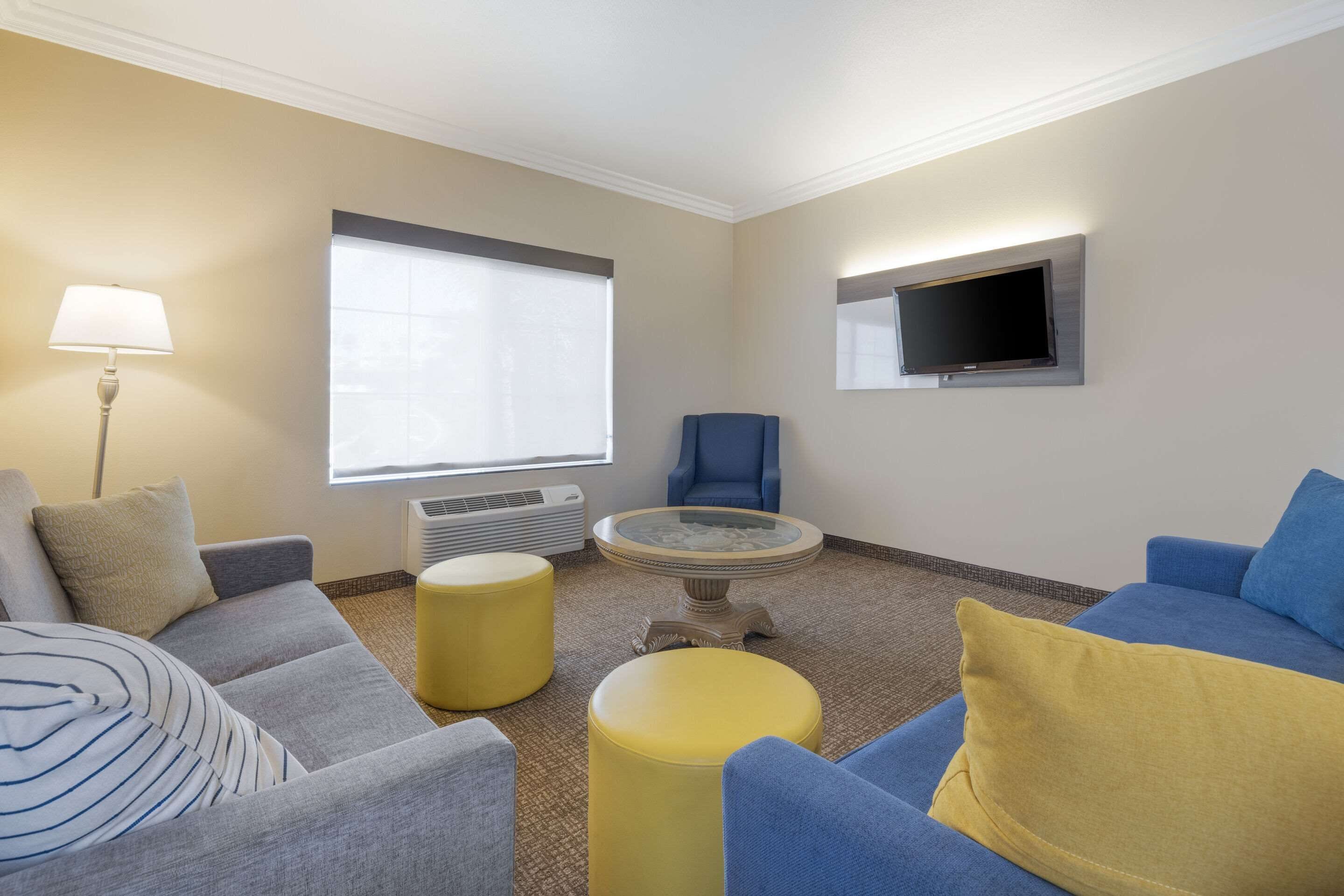 superior suite, 1 king bed, sofa bed, living room, hot tub, non smoking | premium bedding, in-room safe, desk, laptop workspace