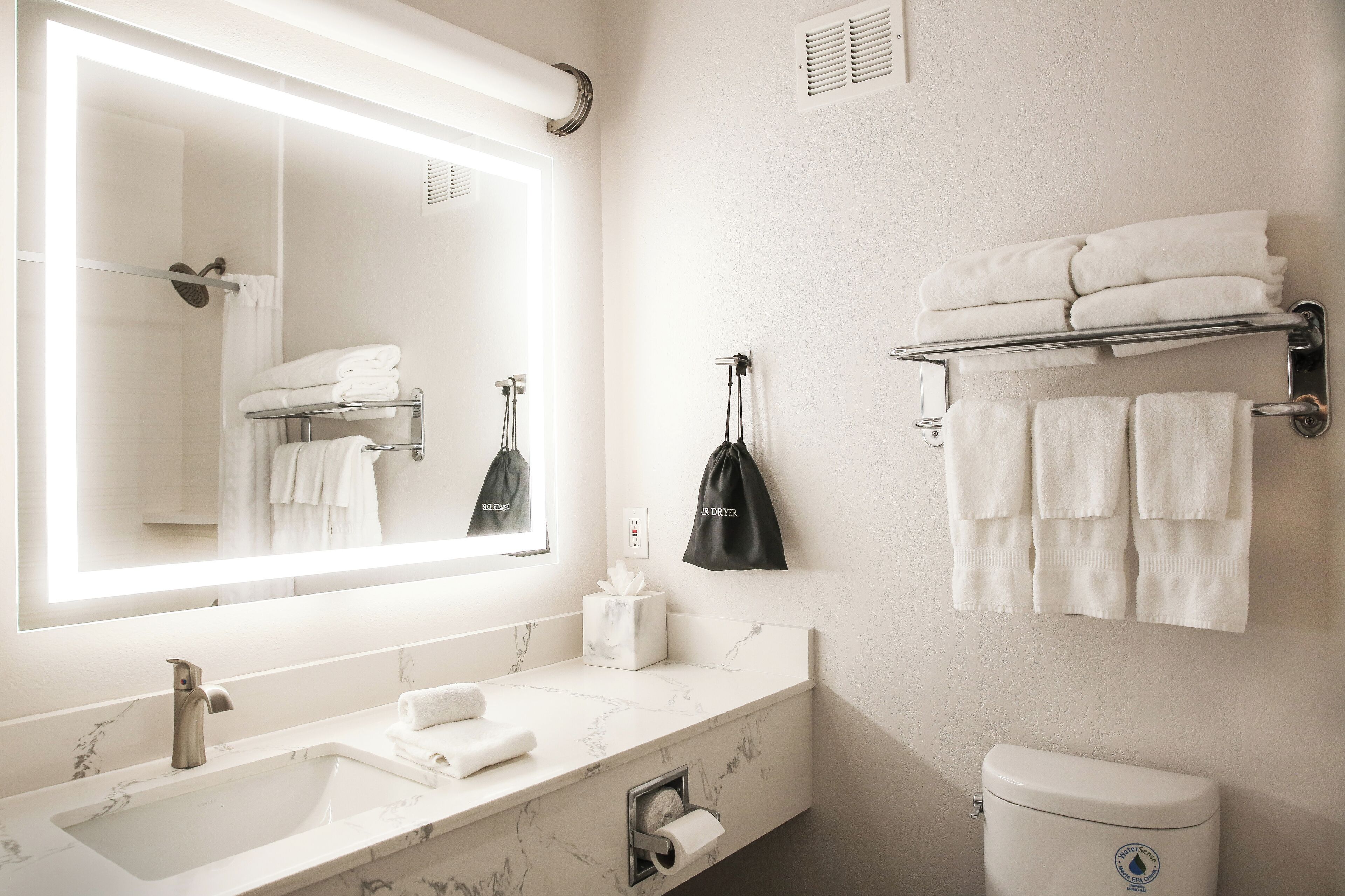 combined shower/bathtub, designer toiletries, hair dryer, towels