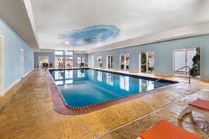 An indoor swimming pool with clear blue water, surrounded by a tiled floor, and a ceiling mural. - Comfort Suites Goodlettsville Rivergate (Goodlettsville)