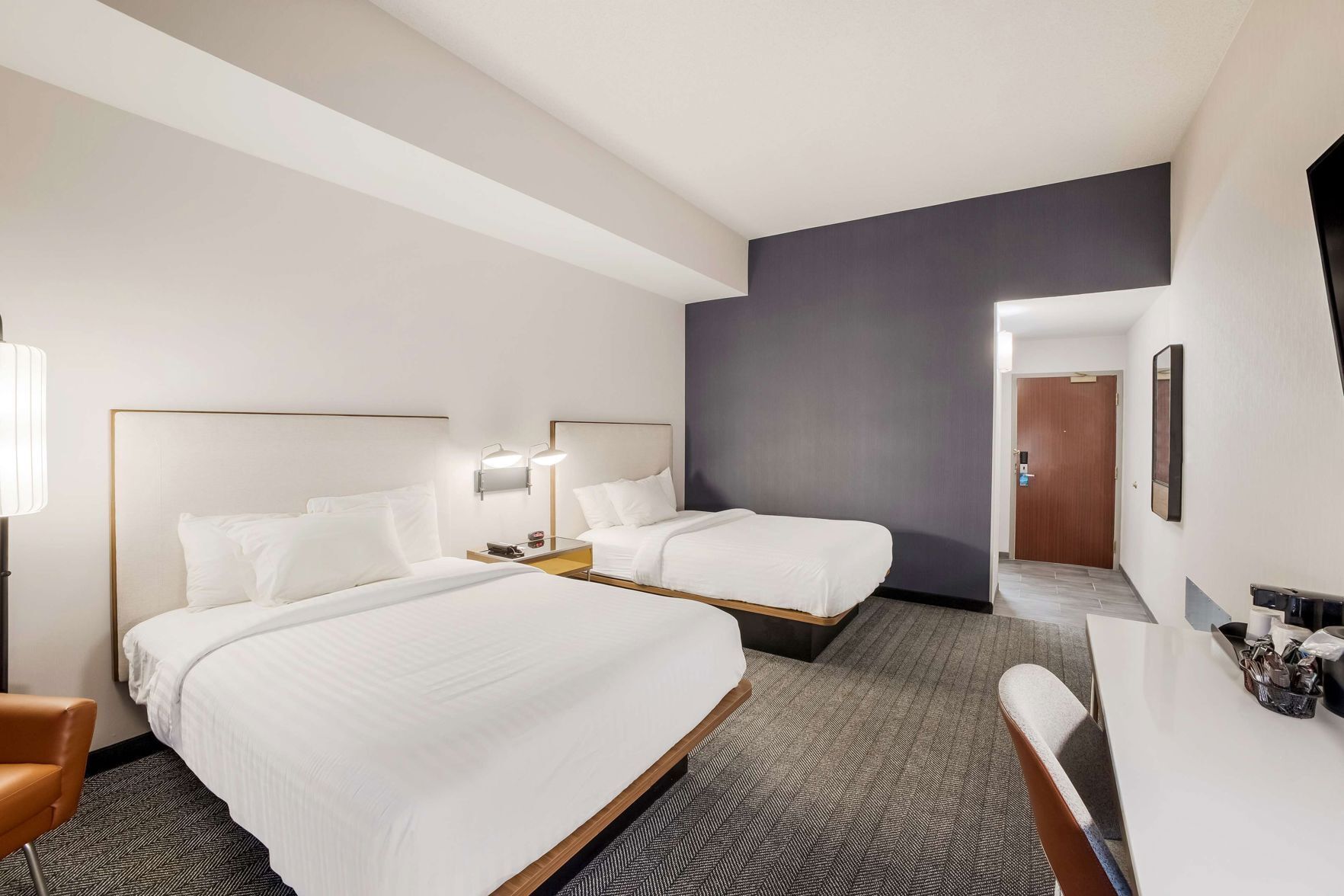 Premium bedding, desk, laptop workspace, blackout drapes